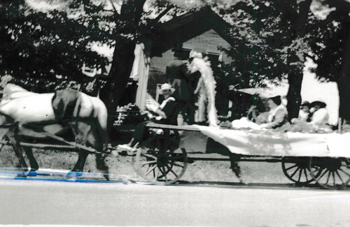 Four wheel farm wagon drawn by two horses with a wedding party